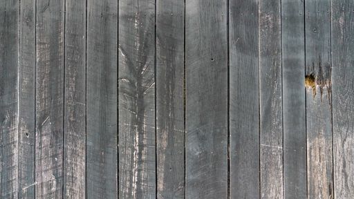 A closeup shot of an old rural wooden wall in dark gray texture background