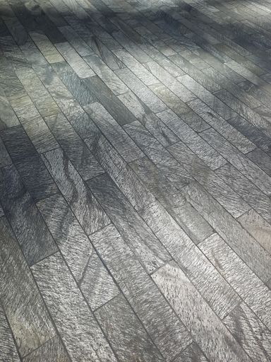 A grayscale shot of the floor of the Singapore Changi Airport under the lights