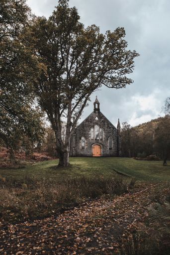 A vertical shot of a small church surrounded by nature, Scotland