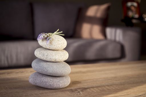 A selective focus shot of a pile of rocks on the table with a couch on the background