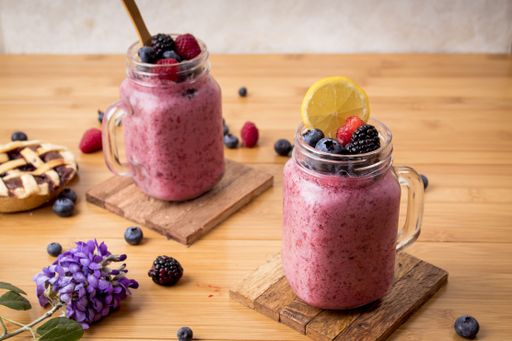 A high angle shot of two smoothies of fresh berries in glass containers