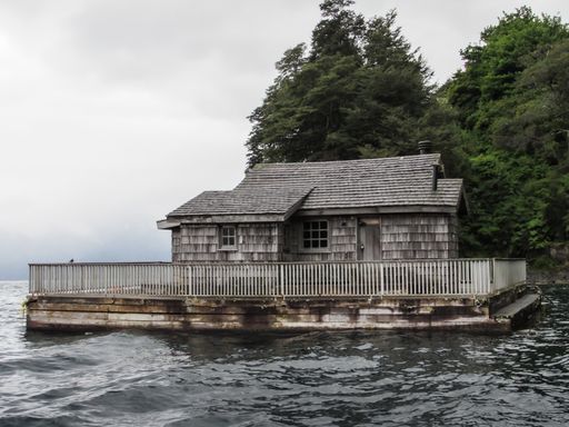 A closeup shot of an old wooden abandoned house in the sea during gloomy weather