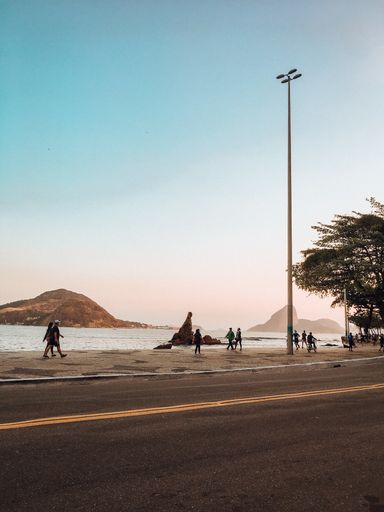 Vertical shot of people exercising during covid times in Rio de Janeiro beach.