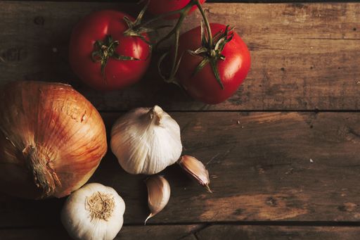 An overhead shot of vegetables placed on a wooden surface - perfect for background