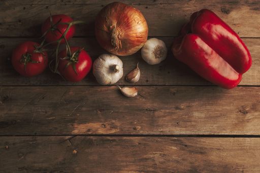 An overhead shot of vegetables placed on a wooden surface - perfect for background