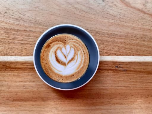 A closeup of a cup of coffee with a beautiful pattern on the surface. Latte art.