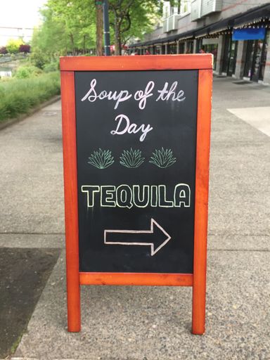 A restaurant signage on the chalkboard with a text soup of the day, tequila
