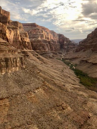 A vertical of a river flowing through Grand Canyon, Arizona  at cloudy sunset