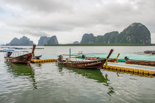 The boats moored near the shore. Phuket, rainforested, mountainous island in the Andaman Sea, Thailand.