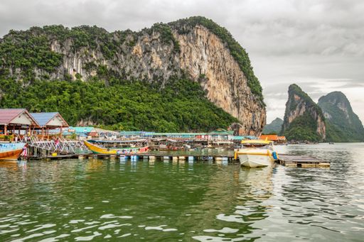 The boats moored near the shore. Phuket, rainforested, mountainous island in the Andaman Sea, Thailand.