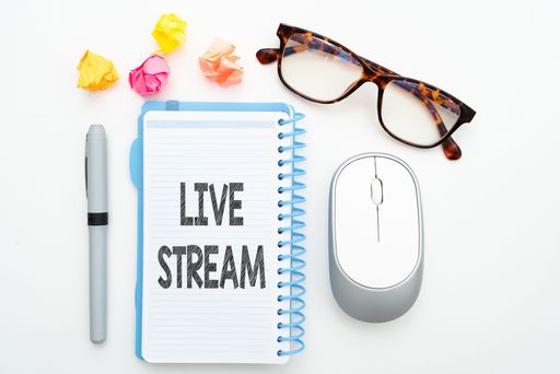 A colorful illustration of glasses, a mouse, candies, a pen and a notebook with live stream text on it