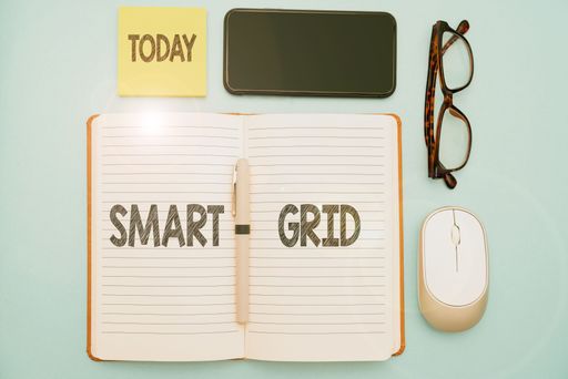 A colorful illustration of glasses, a mouse, a phone a notebook with smart grid text in it