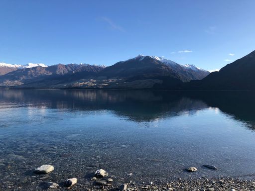 An aerial view of a beautiful lake near the mountains in winter