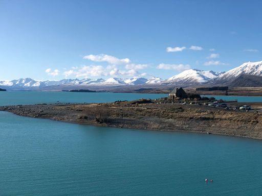 An aerial view of a beautiful lake near the mountains in summer