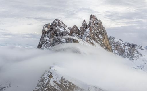 A beautiful snow covered mountain in fog