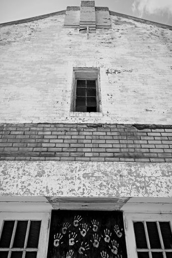 A low angle of a building in black and white.