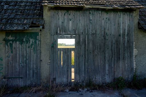An old wooden abandoned house in the village on a sunny day