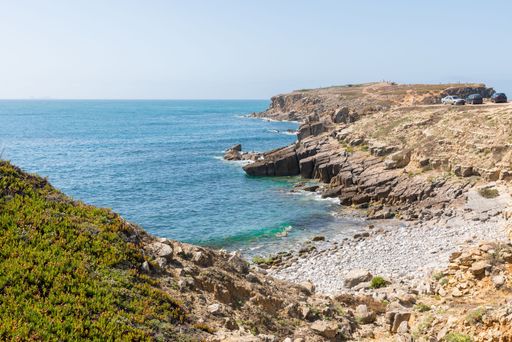 The rocky shoreline of the blue sea in the islet of Papoa in Peniche, Portugal