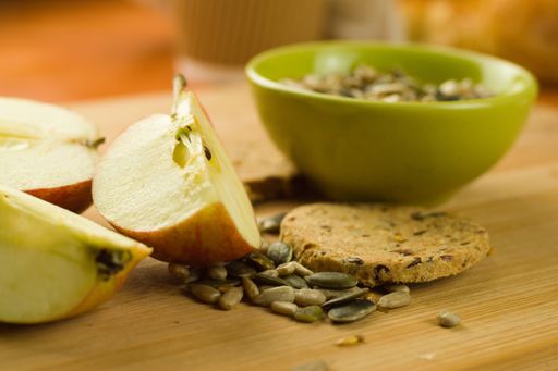 A closeup shot of oatcakes with apples and seeds on a table