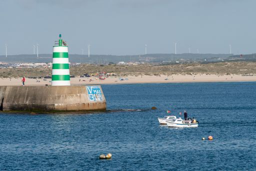 A closeup of small motorboats sailing along the Peniche sea in the district of Leiria, Portugal