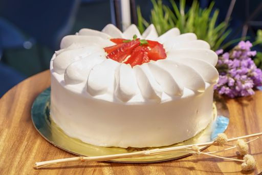 A strawberry cake on the wood background