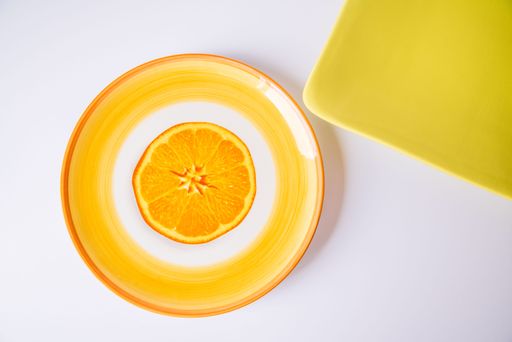 A set of old plates with drawing of an orange and another green square plate