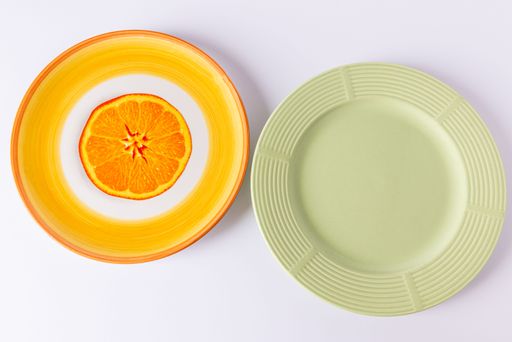 A set of old plates with drawing of an orange and another green square plate