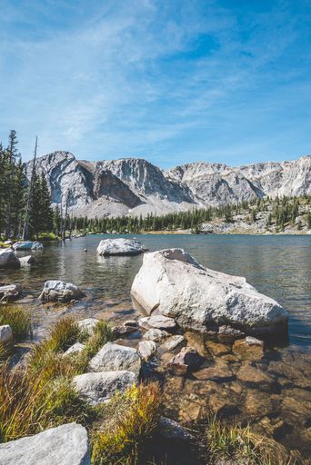 A vertical shot of a beautiful lake near the mountains