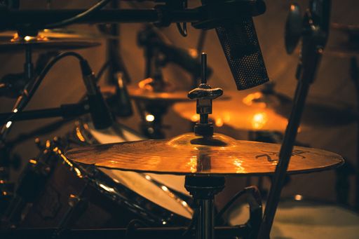 A Microphone placed above the hi-hat cymbal in a recording studio