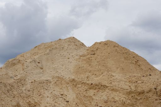 A sand hill of a construction area on a cloudy day