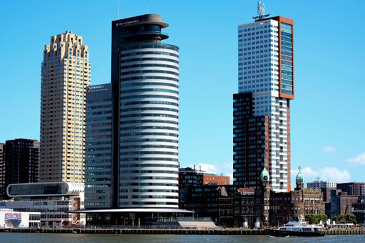 Tall buildings built next to the old city against the blue sky, Kop van Zuid, Rotterdam Netherlands