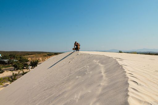 A tourist in the beautiful sand dunes and vibrant summer at Phan thiet, Vietnam