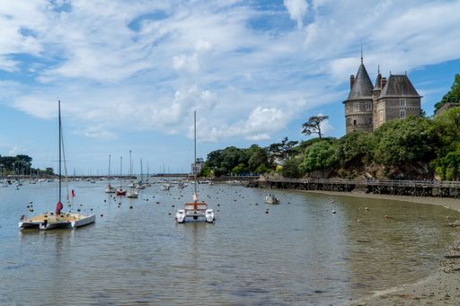 The port of Pornic with traditional fishing boata and the Chateau de Pornic castle in the background