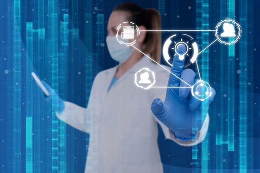 A nurse in uniform pointing upwards at holograms representing global innovative thinking.