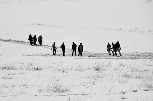 A black and white shot of people on lake Gurigol during the winter