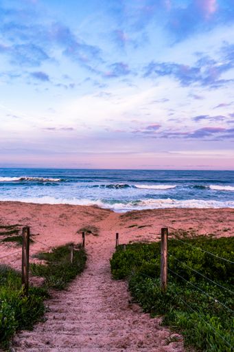 A vertical landscape shot of a beautiful colorful sunset at the beach