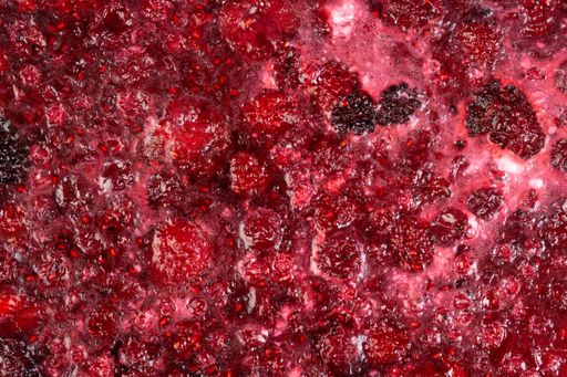 A high angle closeup shot of the delicious and homemade raspberry jam