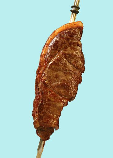 A closeup shot of picanha isolated on blue background
