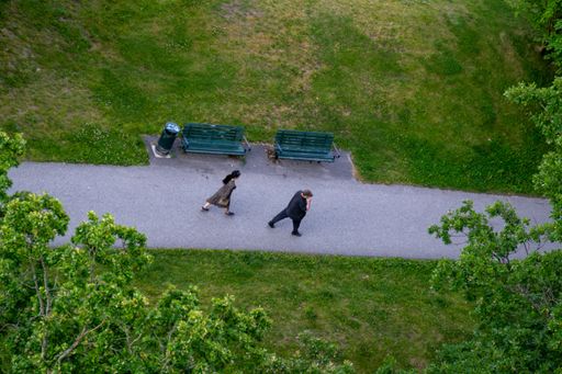 A high angle shot of a man and woman walking on a pathway