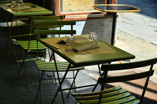 The empty restaurant tables set in the terrace waiting customers for dinner