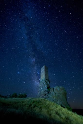 A panoramic shot of the Castillio de Zafra in Spain with a starry background