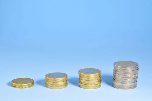 euro coins scattered on blue background