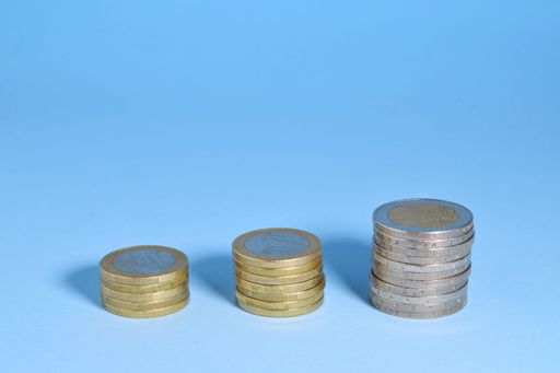 euro coins scattered on blue background