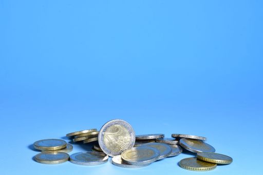 euro coins scattered on blue background