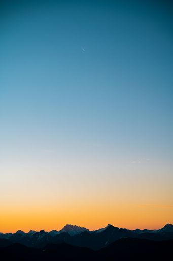 A beautiful view of huge mountains during orange sunset