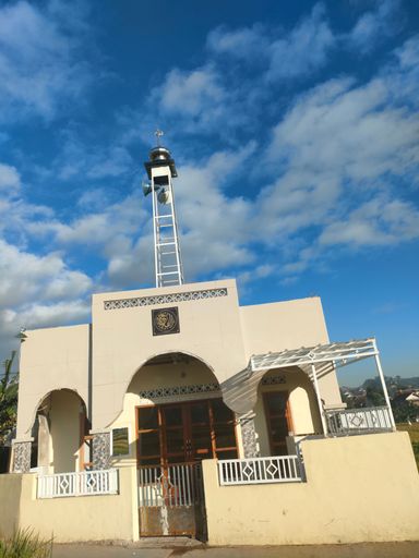 A low angle shot of a temple with a cloudy sky above