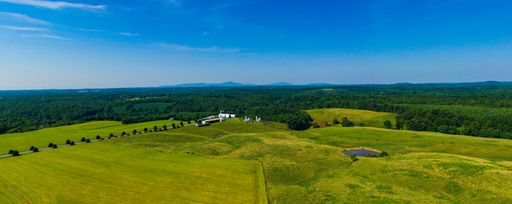 A panoramic shot of a beautiful landscape of farmland and mountains in Virginia, USA