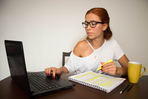 A closeup shot of a young female studying at home - study at home concept