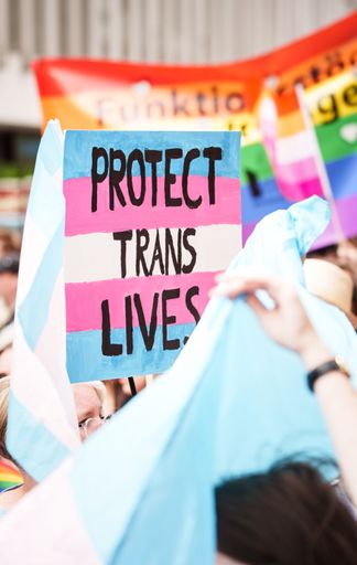 A sign saying Protect Trans Lives being held up during the Pride march in Malmo Sweden July 2022