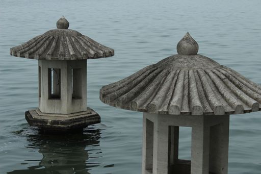 A closeup shot of old Japanese lanterns in a lake
